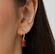 Pink sapphire hoop earrings featuring vibrant pink gemstones set in elegant hoops for a chic, feminine sparkle.